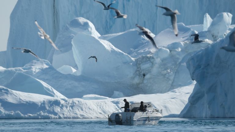 ILULISSAT, GREENLAND - AUGUST 04: A man fishes near icebergs in the Ilulissat Icefjord on August 04, 2019 in Ilulissat, Greenland. As the Earth's climate warms summers have become longer in Ilulissat, allowing fishermen a wider period to fish from boats on open waters and extending the summer tourist season. Long term benefits are uncertain, however, as warming waters could have a negative impact on the local fish and whale population. (Photo by Sean Gallup/Getty Images)