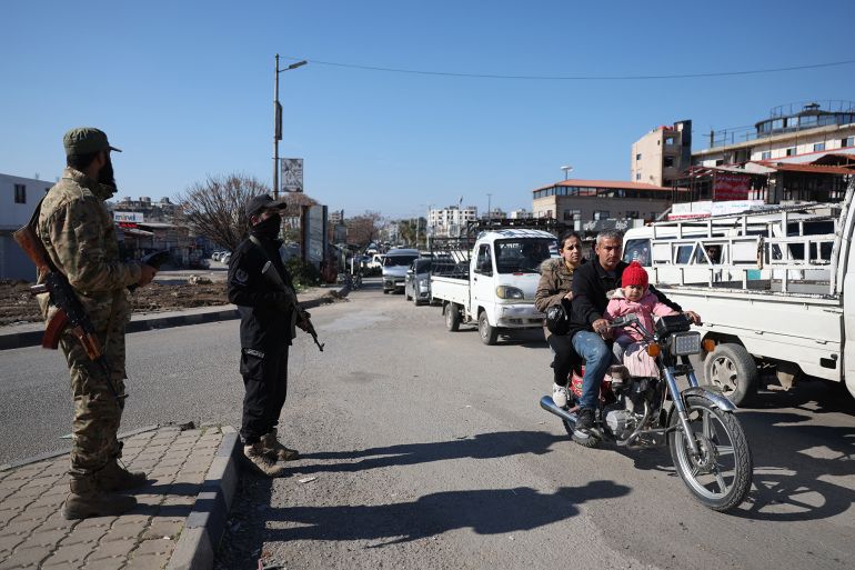 Members of the security forces with Syria's new government man a checkpoint at the entrance of the Syrian town of Jableh in the coastal province of Latakia, on January 28, 2025. After Islamist-led rebels ousted longtime ruler Bashar al-Assad on December 8, the new authorities sought to reassure minorities in multi-ethnic multi-confessional Syria that they will be protected. (Photo by OMAR HAJ KADOUR / AFP)
