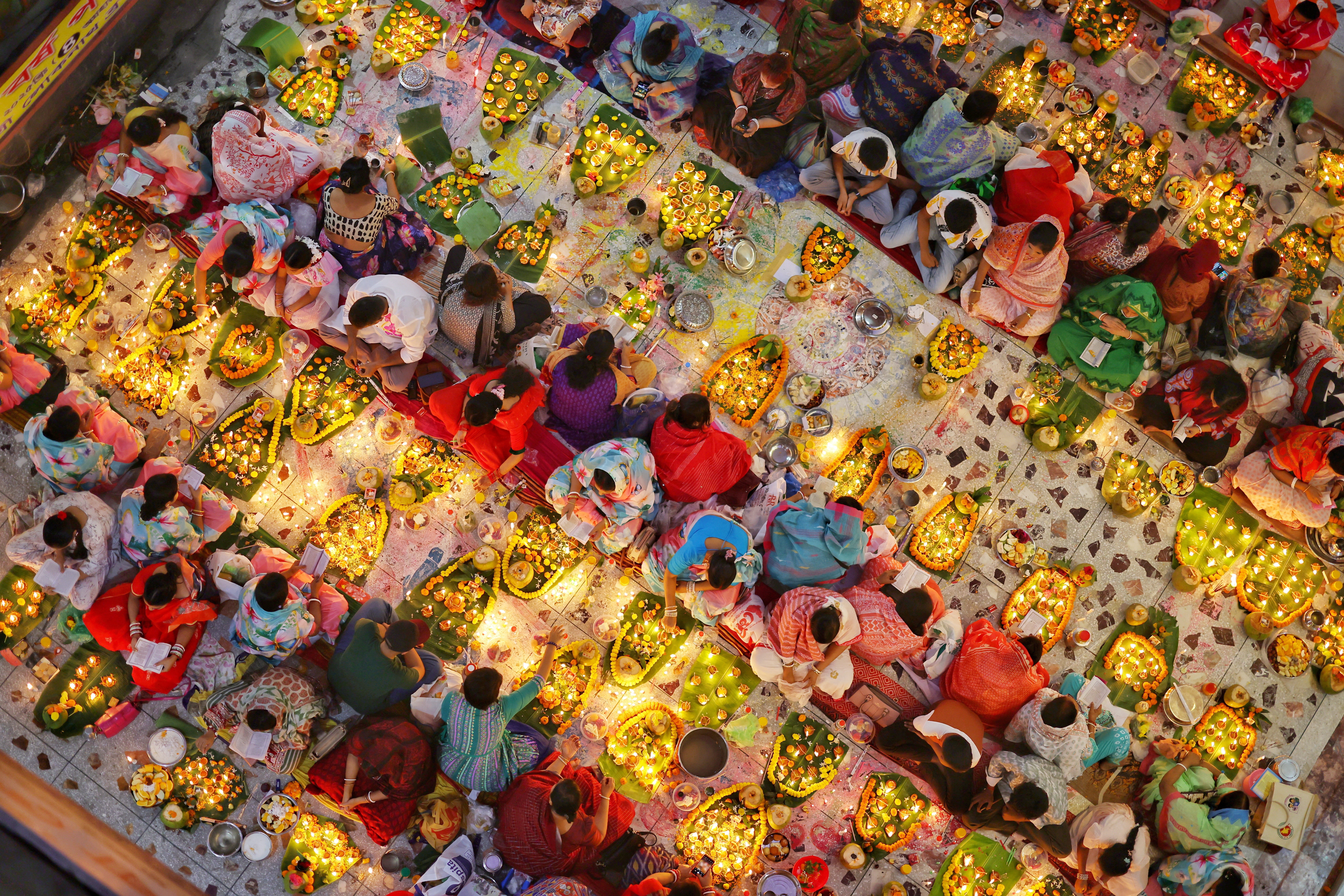 Hindu devotees sit together with oil lamps to pray to Lokenath Brahmachari, a Hindu saint and philosopher, as they observe the Rakher Upobash festival at a temple in Dhaka, Bangladesh, November 4, 2025. REUTERS/Mohammad Ponir Hossain