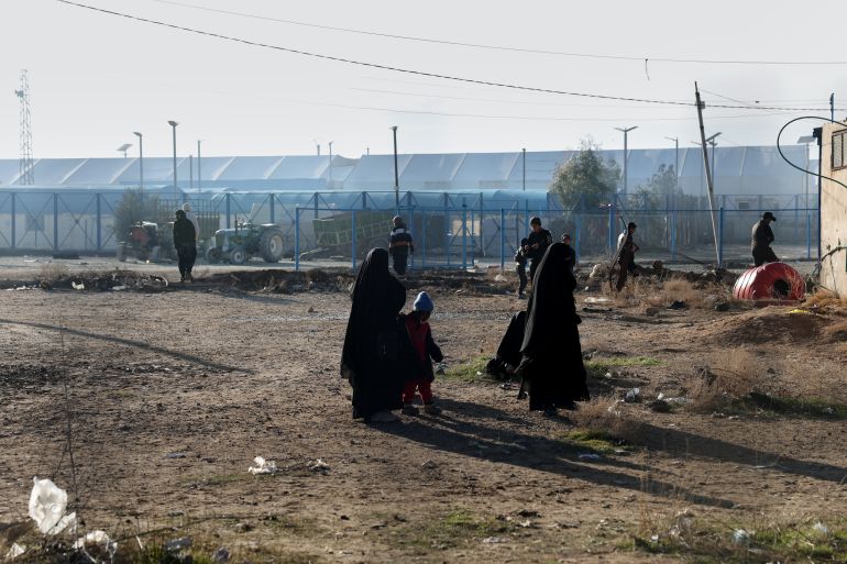 People walk inside the al-Hol camp in northeastern Syria's Hasakeh province, Syria, Wednesday, Jan. 21, 2026, after the withdrawal of the Syrian Democratic Forces (SDF). (AP Photo/Ghaith Alsayed)
